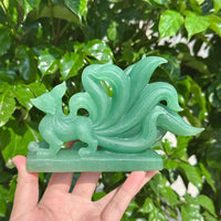 Detailed side view of Green Strawberry Quartz Nine-Tailed Fox Carving with elegant craftsmanship.