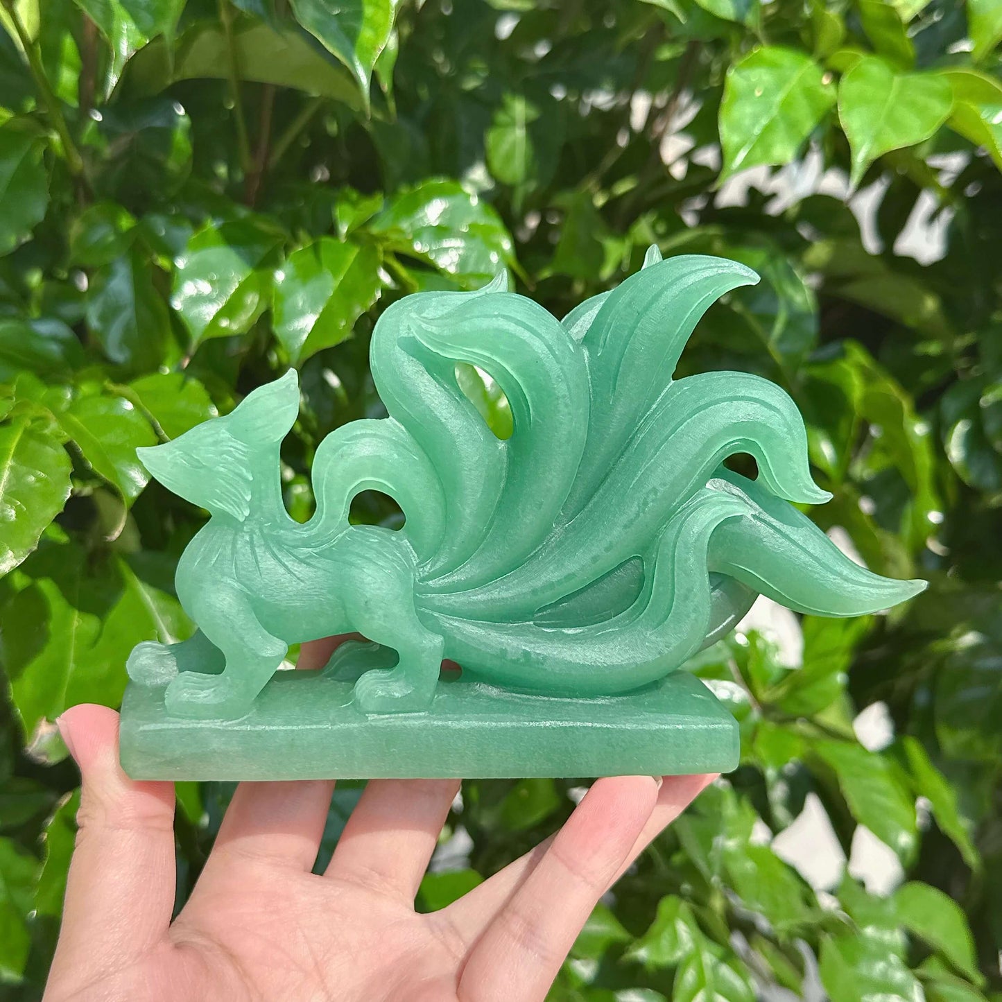 Detailed side view of Green Strawberry Quartz Nine-Tailed Fox Carving with elegant craftsmanship.