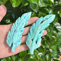 Close-up of the Hemimorphite Feather Carving with distinct feather patterns in soothing blue tones.