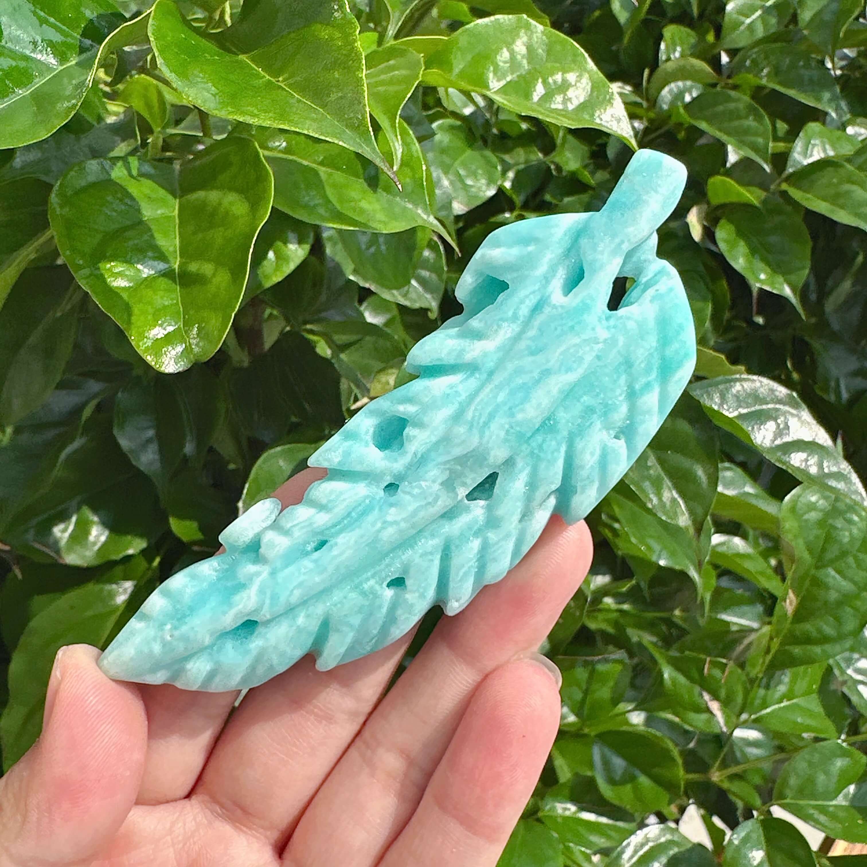 Elegant Hemimorphite Feather Carving with intricate detailing and rich blue colors.