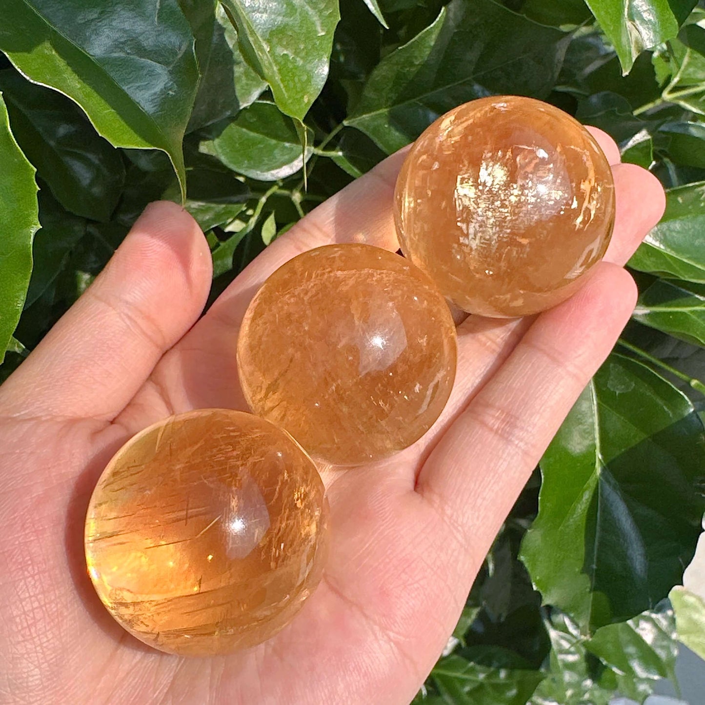 Close-up view of Honey Calcite Sphere, displaying intricate patterns and warm golden color.