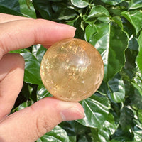 Honey Calcite Sphere showcasing its smooth surface and natural golden hues.