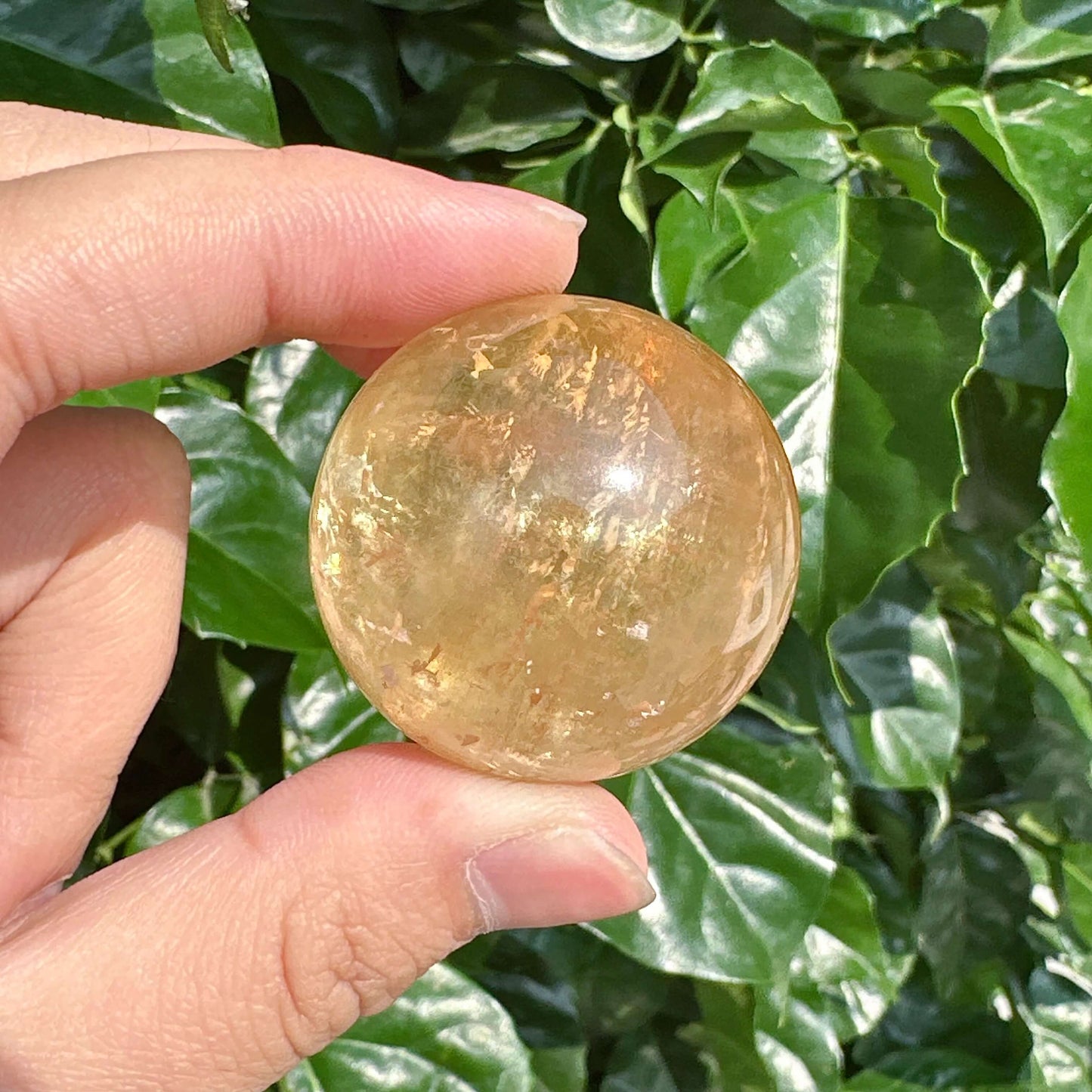Honey Calcite Sphere showcasing its smooth surface and natural golden hues.