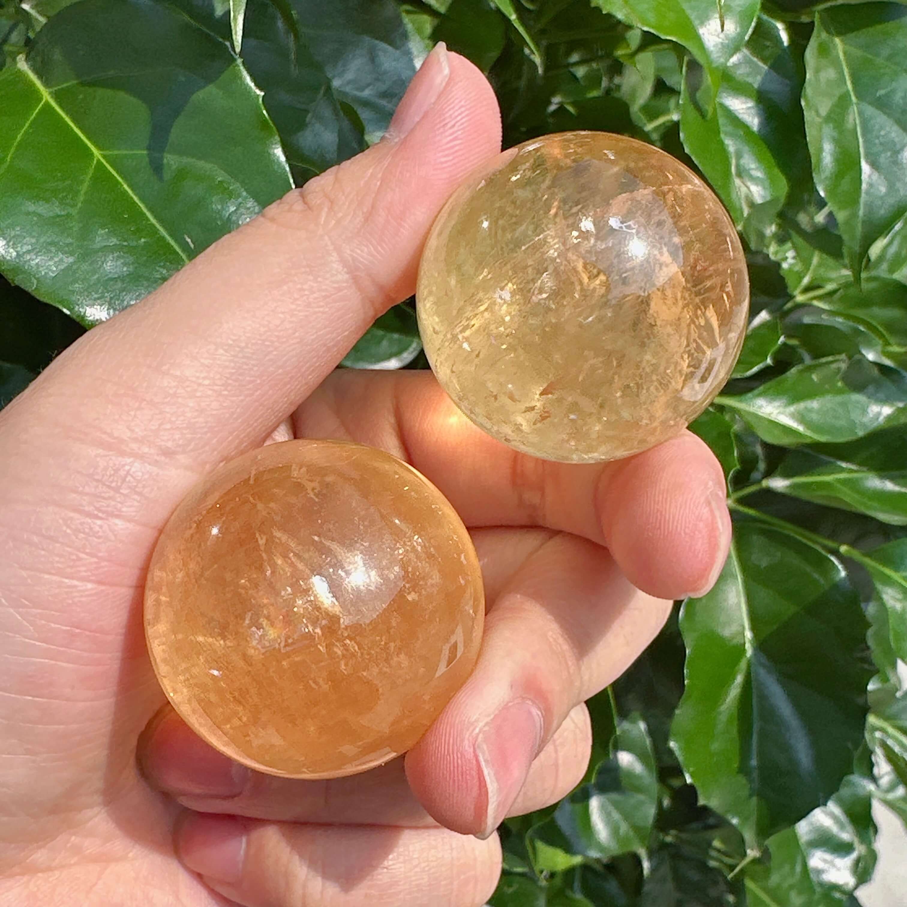 Side view of Honey Calcite Sphere, highlighting its beautiful transparency and crystal structure.