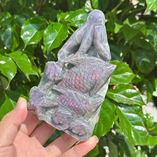 Side view of the Labradorite octopus carving highlighting its smooth surface and natural play of light.