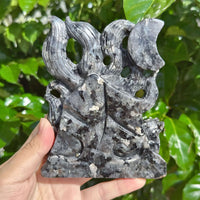 Close-up of the Larvikaite Nine-Tailed Fox Carving with a focus on its fine texture and stone patterns.