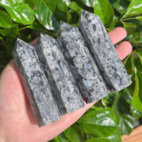 Elegant Larvikite tower with striking natural patterns, ideal for energy work and decoration.