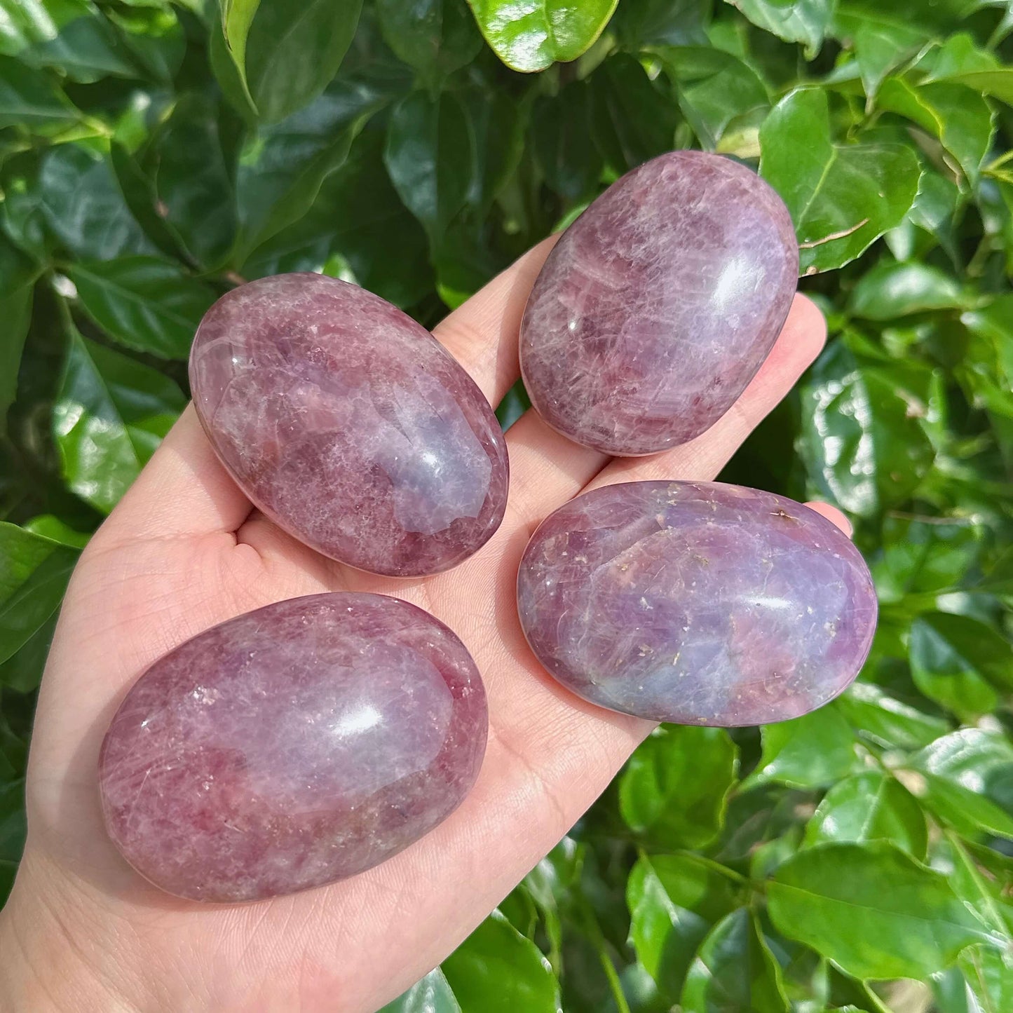 Lavender Rose Quartz Palm Stone, showcasing the smooth texture and natural lavender hues of the crystal. Ideal for healing and relaxation.