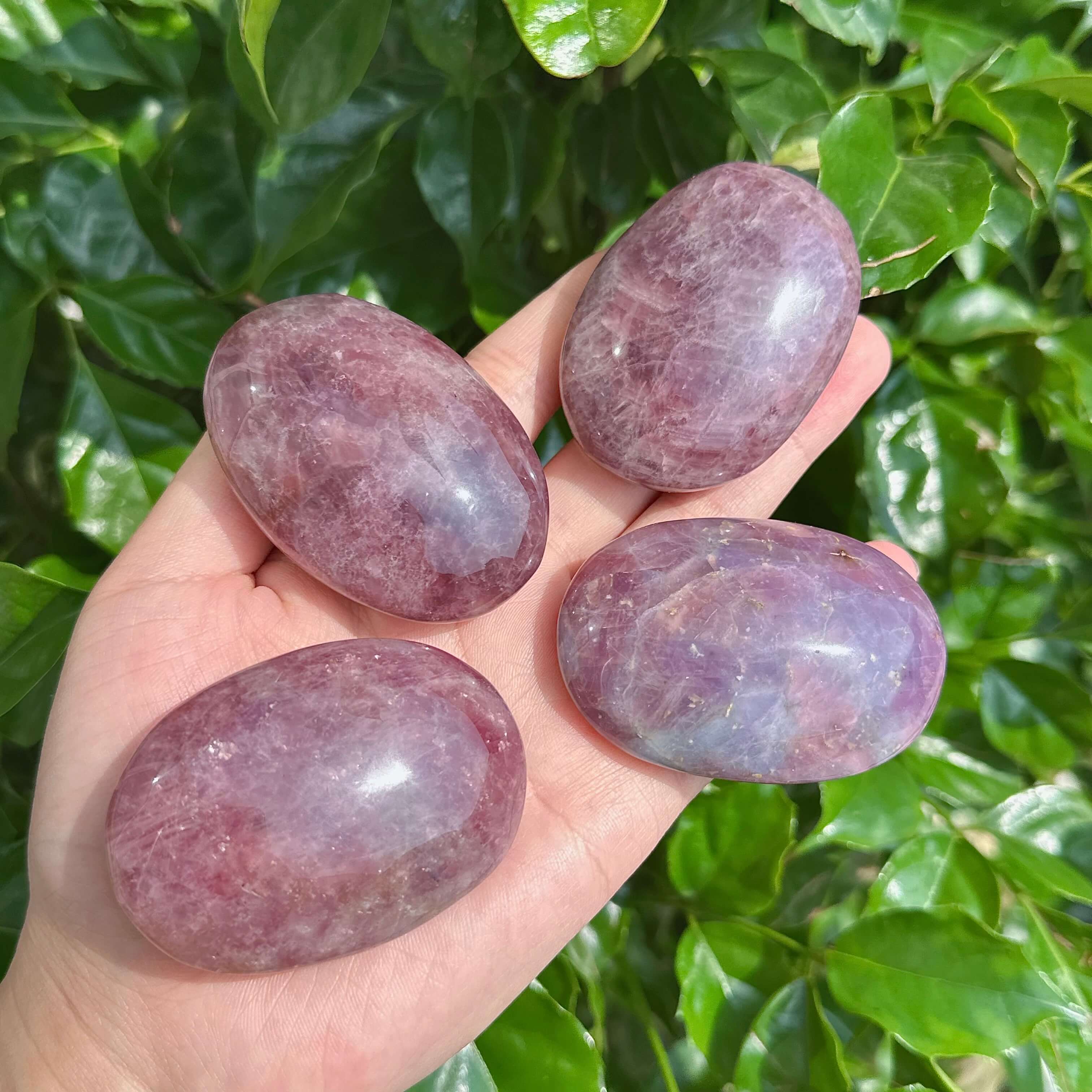 Lavender Rose Quartz Palm Stone, showcasing the smooth texture and natural lavender hues of the crystal. Ideal for healing and relaxation.