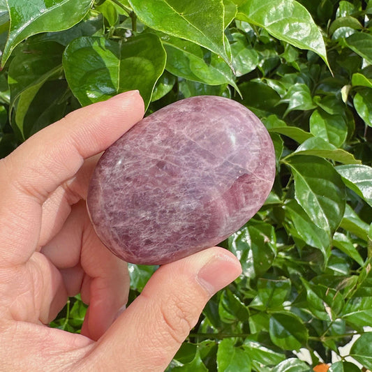 A soothing Lavender Rose Quartz Palm Stone with a soft, polished surface, ideal for calming energy and enhancing emotional balance.