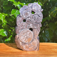 Carved Lepidolite sculpture featuring a dragon and floral elements, symbolizing balance.