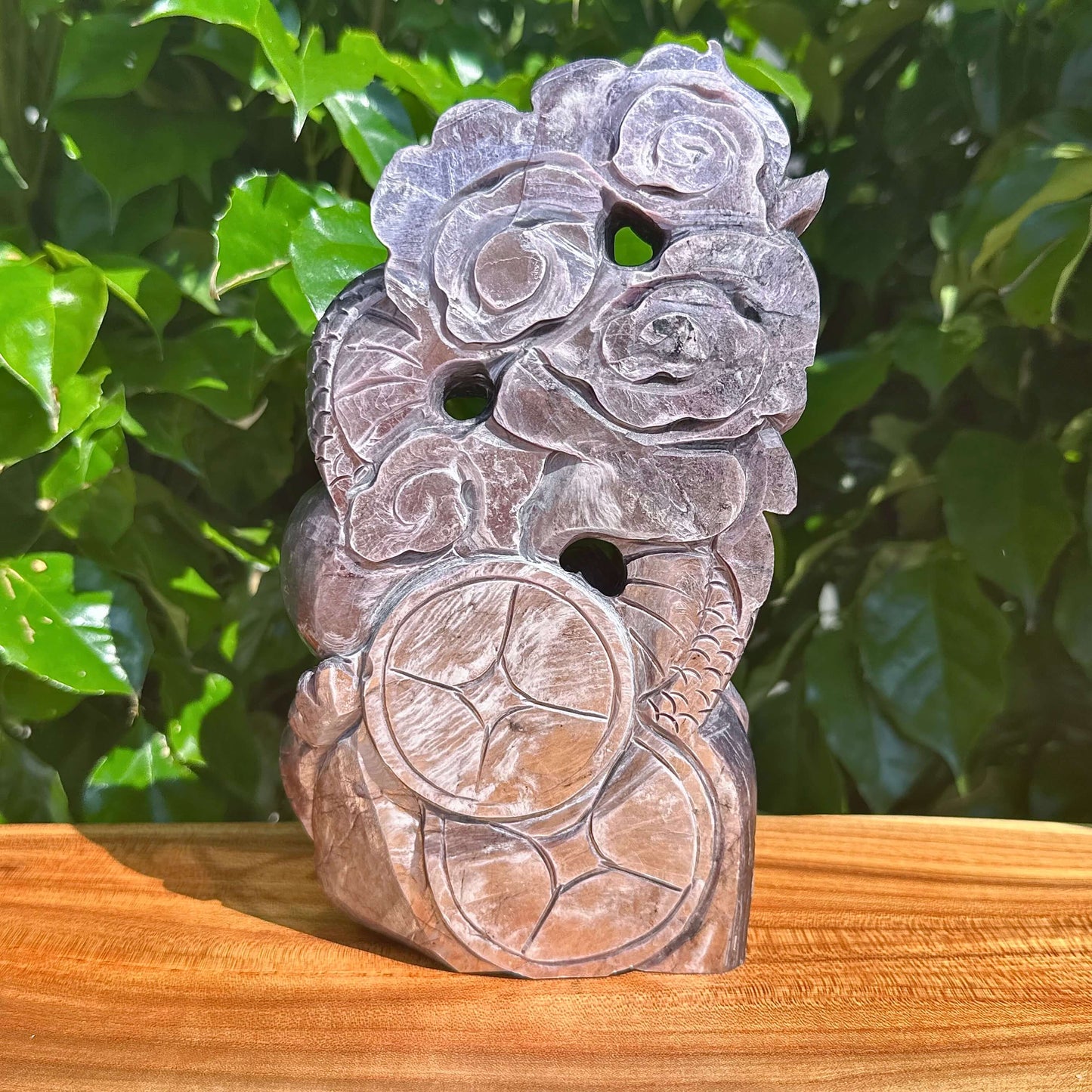 Carved Lepidolite sculpture featuring a dragon and floral elements, symbolizing balance.