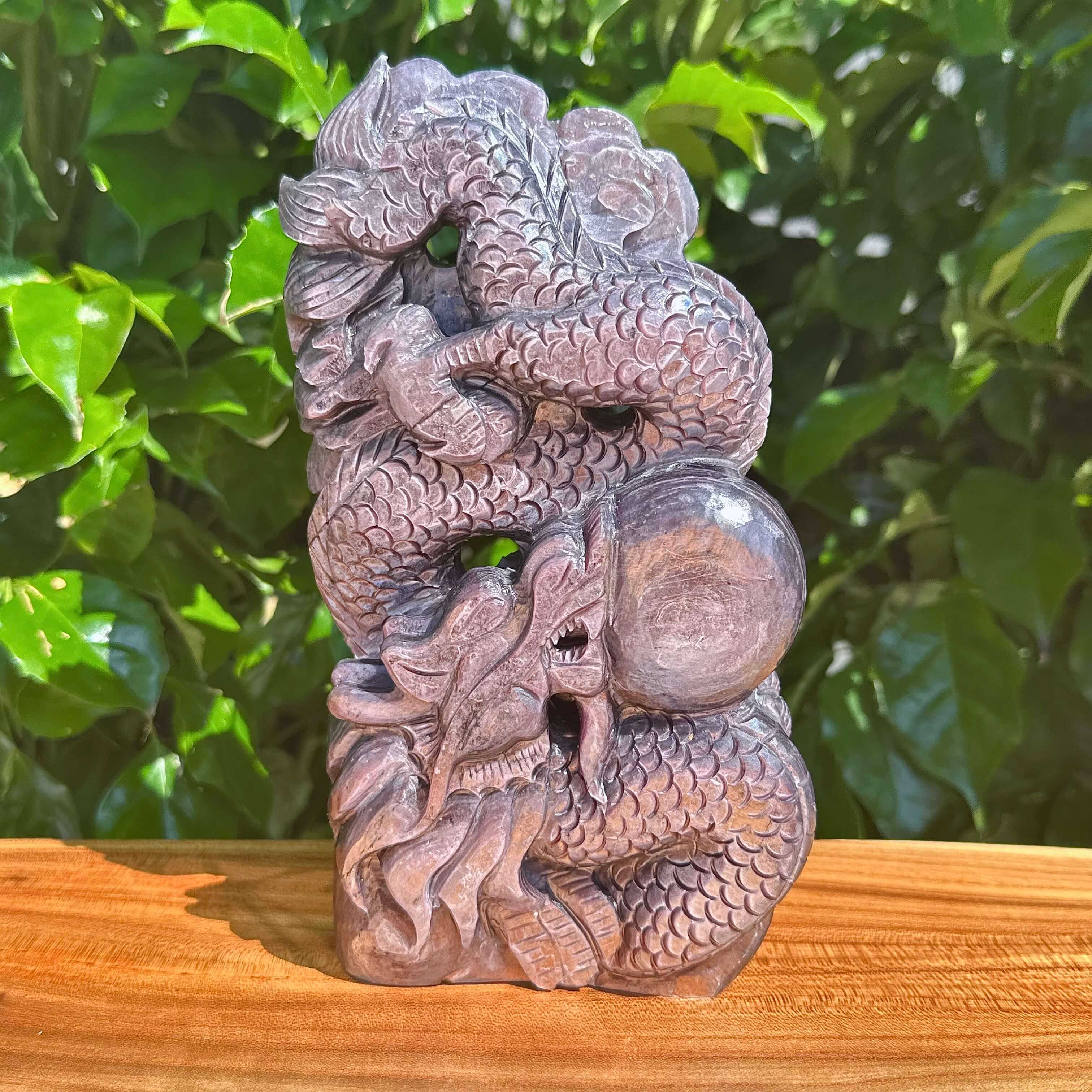 Detailed carving of a dragon and dragon ball in Lepidolite crystal.