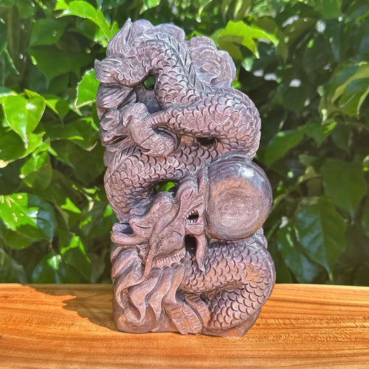 Detailed carving of a dragon and dragon ball in Lepidolite crystal.