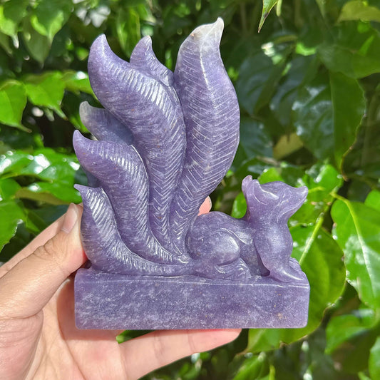 Side view of the Lepidolite Nine-Tailed Fox Carving, highlighting the natural beauty of the crystal.