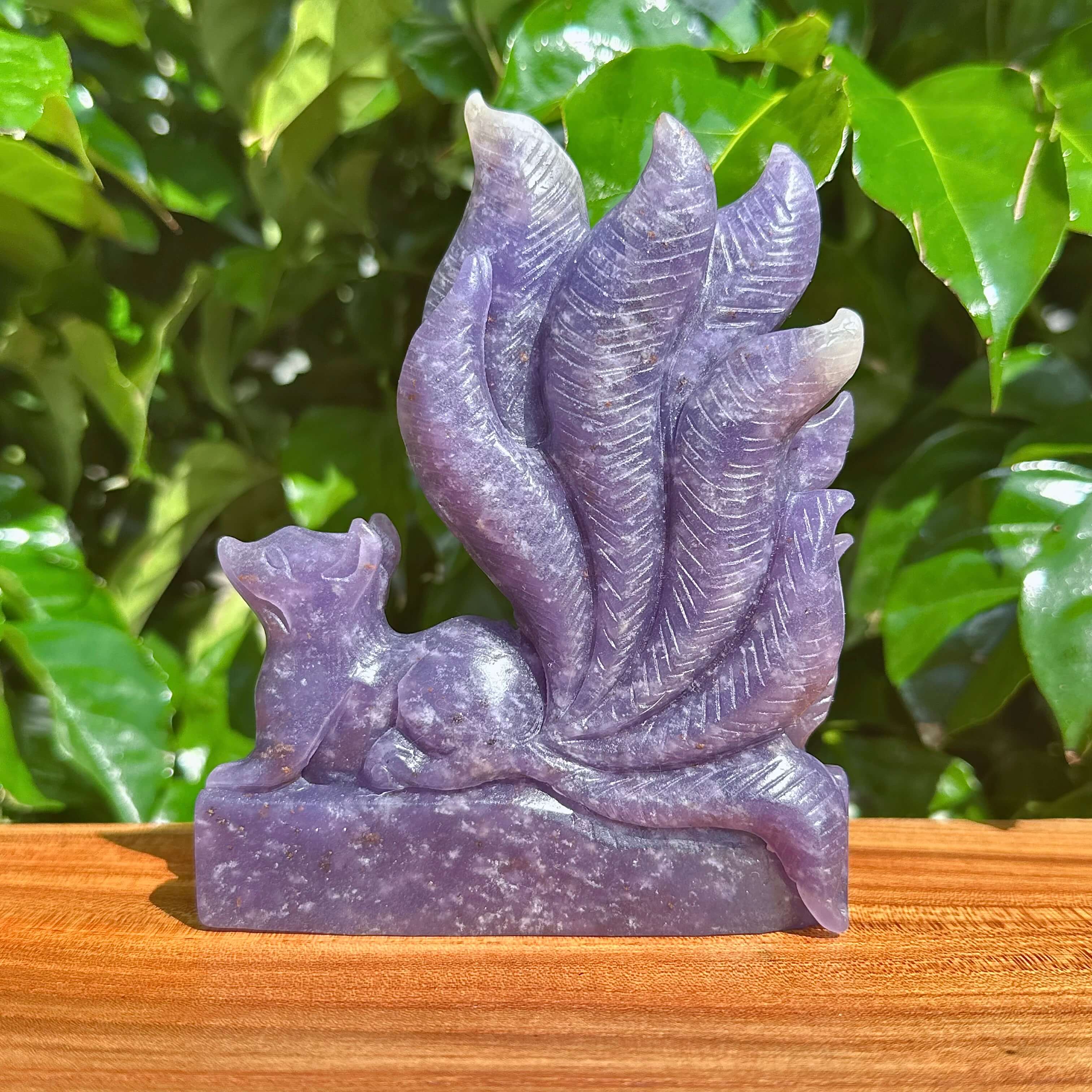 Full view of the Lepidolite Nine-Tailed Fox Carving, capturing the fox and tail details in natural lighting.