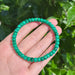 Polished malachite beads bracelet showcasing green hues and smooth finish, perfect for healing and energy balance.