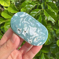 Elegant Moss Agate Palm Stone with rich green hues and soothing textures.
