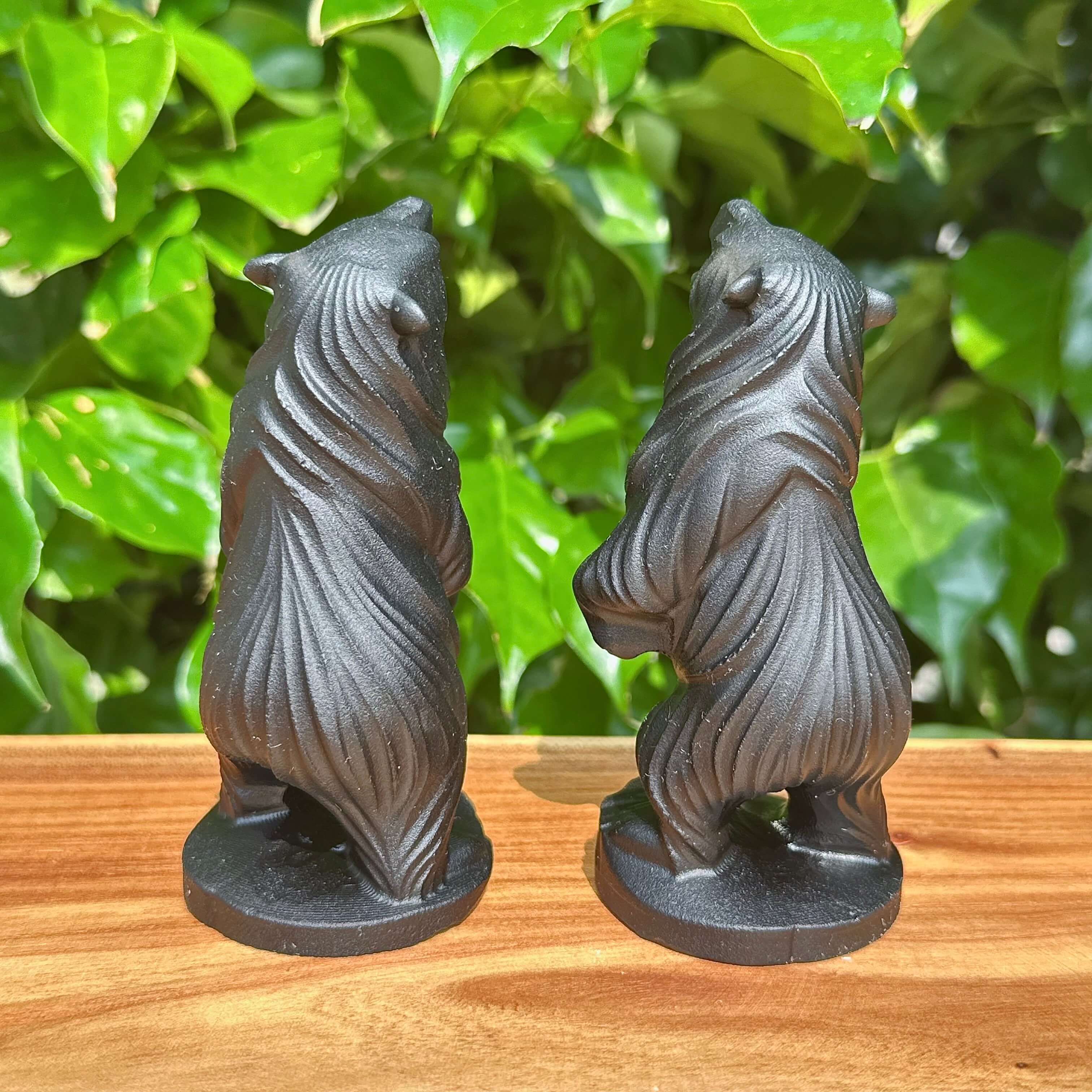 Front and side views of the Obsidian Capibara statue, displaying its detailed features and sleek obsidian surface.