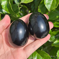 Obsidian egg carving with smooth polished surface, ideal for decoration and spiritual practices.
