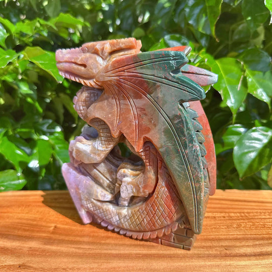 Artistic angle view of the Ocean Jasper Dragon Carving with striking textures and colors.