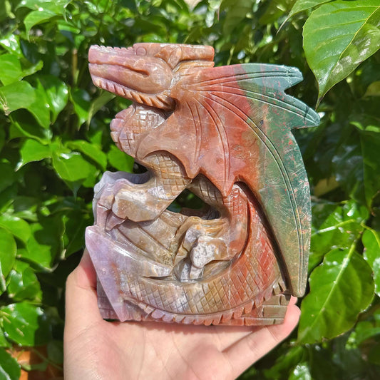 Ocean Jasper Dragon Carving held in hand, emphasizing the intricate details and craftsmanship.