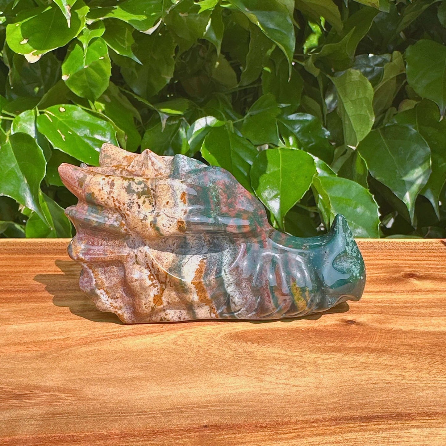 Ocean Jasper Dragon Head Carving beautifully displayed with vibrant hues and exquisite detailing.