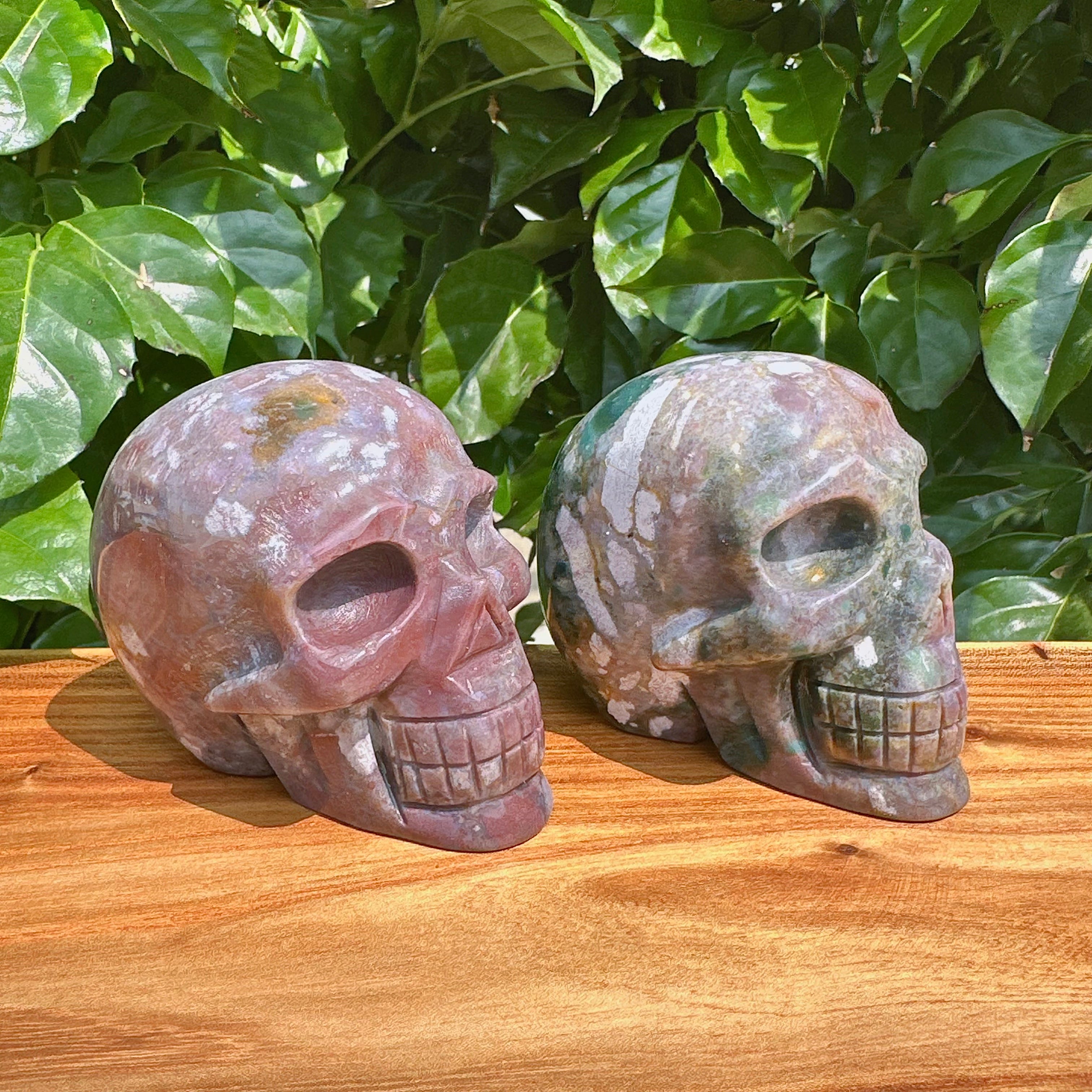 Ocean Jasper skull carving displayed, emphasizing its striking color combination and craftsmanship.
