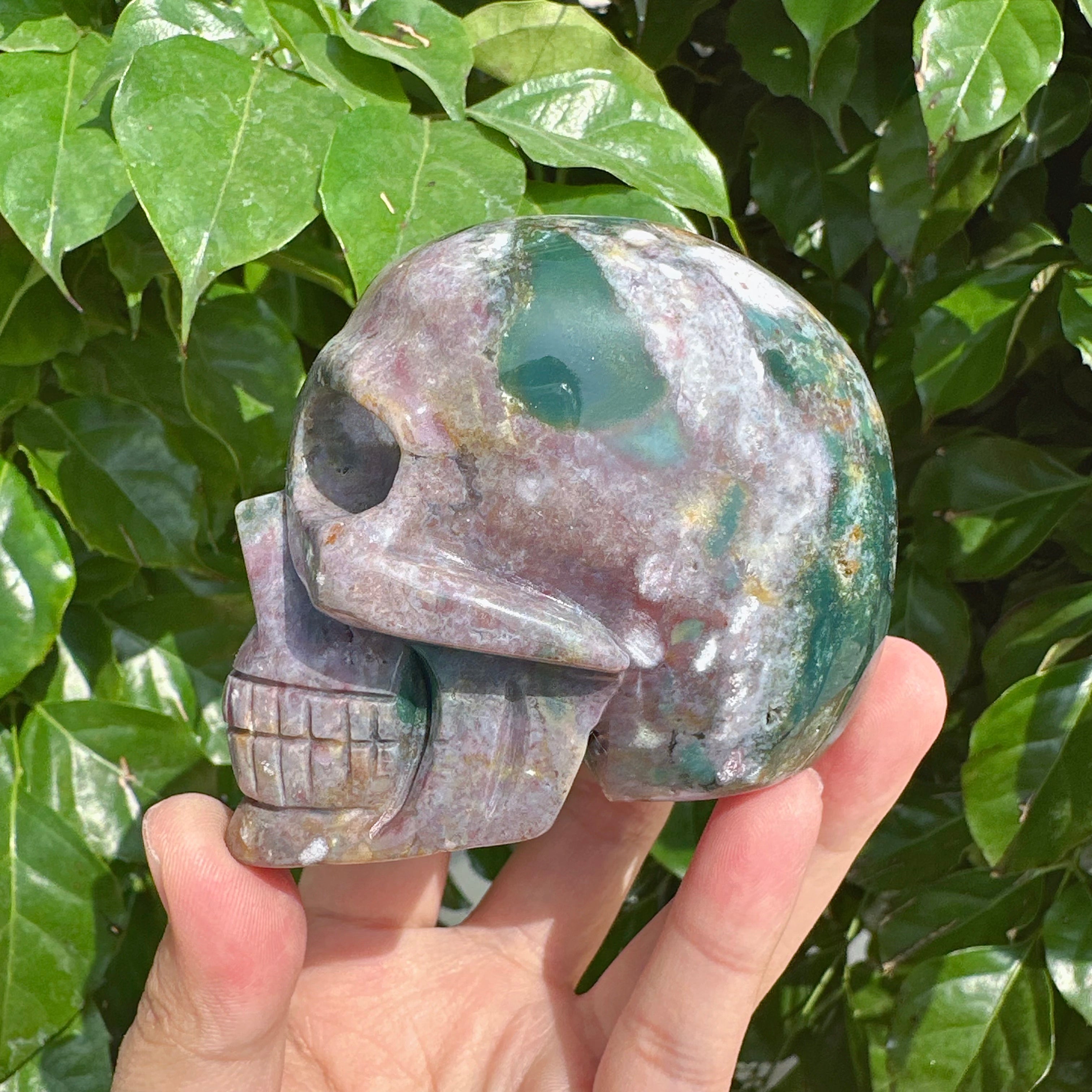 Front view of the Ocean Jasper skull carving showcasing the vibrant colors and unique patterns in the gemstone.