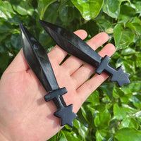 Detailed view of a Pentagram obsidian sword with star-shaped hilt and polished obsidian blade.