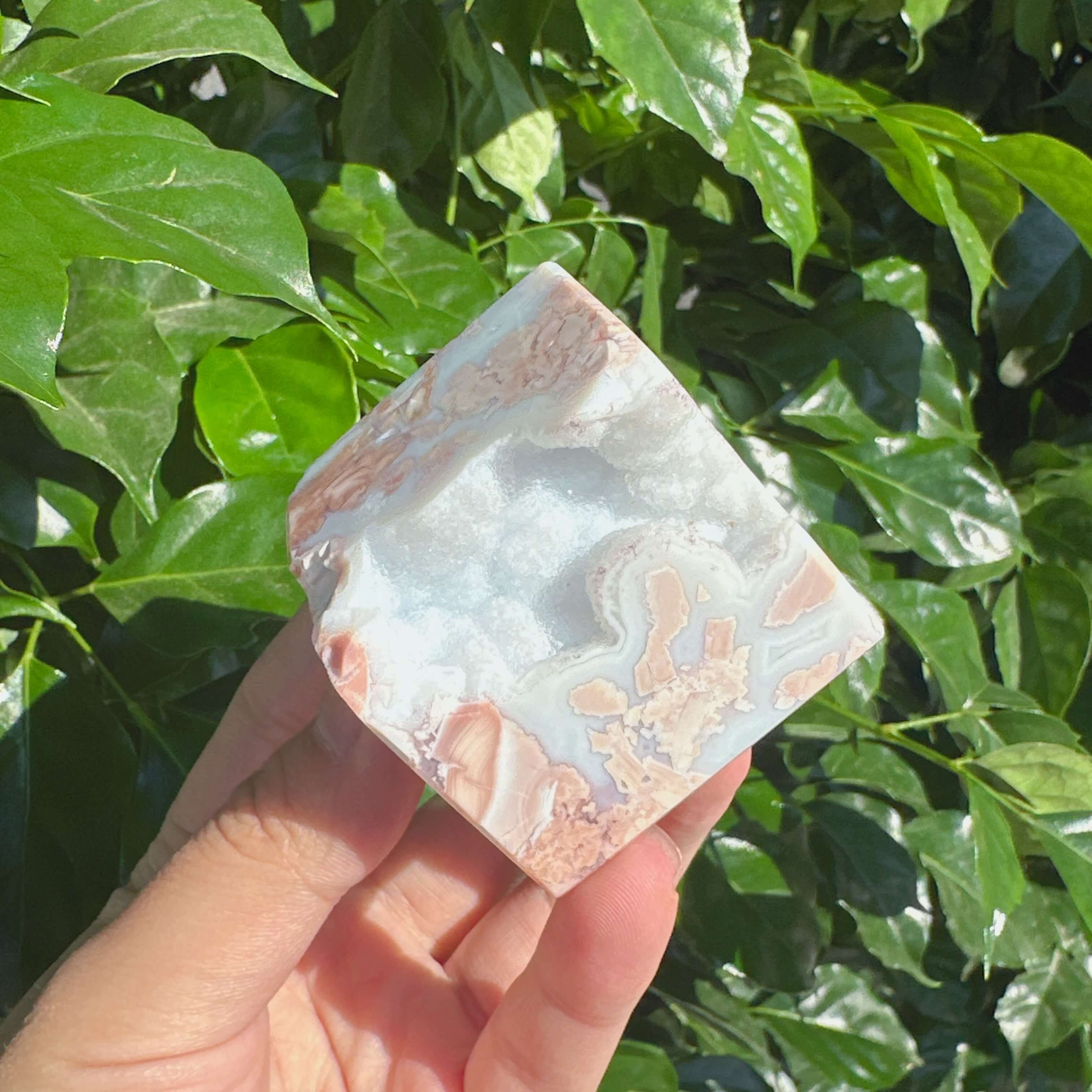 Detailed view of Pink Agate Cube, emphasizing its vibrant pink color and natural crystal inclusions.