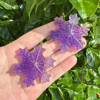 A vibrant Purple Fluorite Snowflake with detailed carving edges and texture.