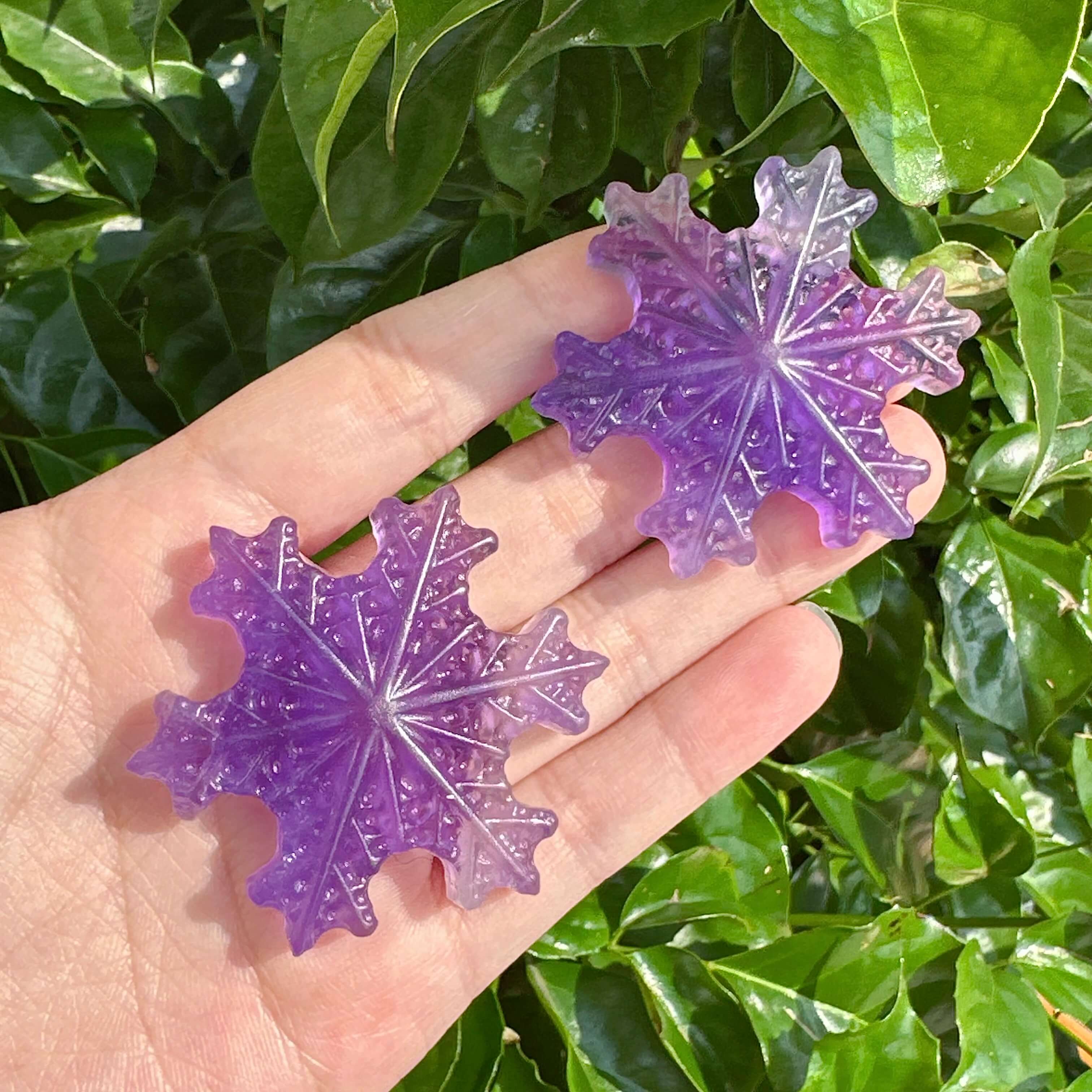 A vibrant Purple Fluorite Snowflake with detailed carving edges and texture.