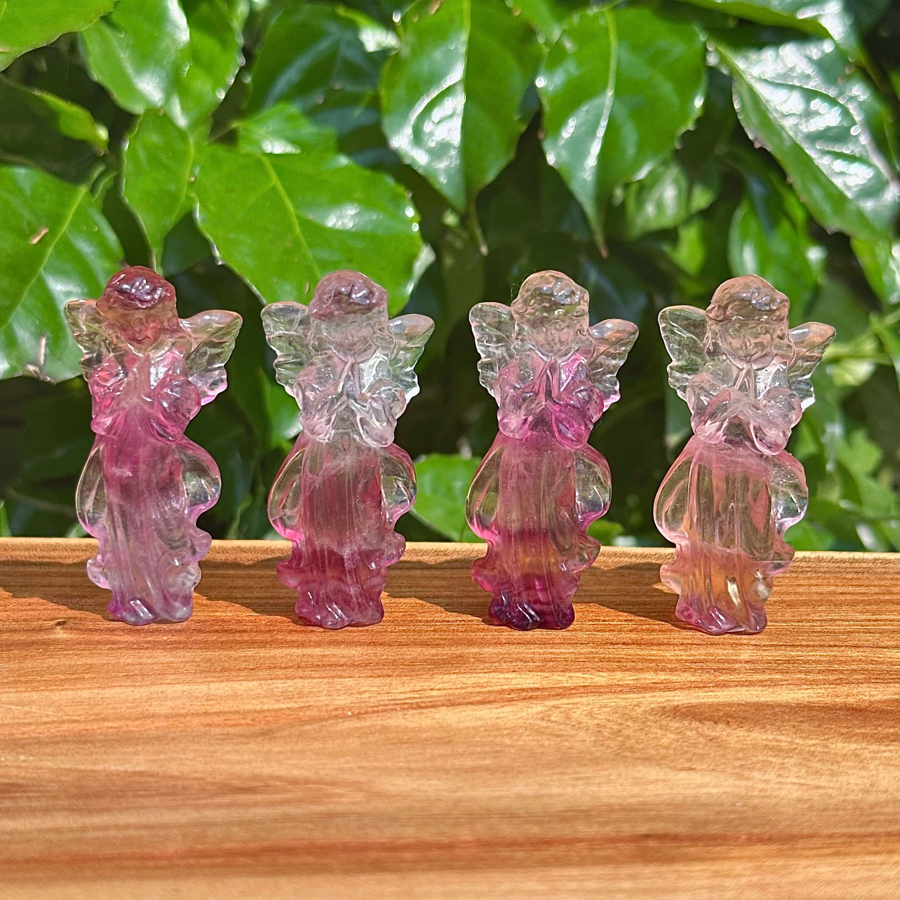 Front view of Rainbow Fluorite angel carving highlighting the intricate wings and tranquil pose.