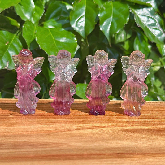 Front view of Rainbow Fluorite angel carving highlighting the intricate wings and tranquil pose.
