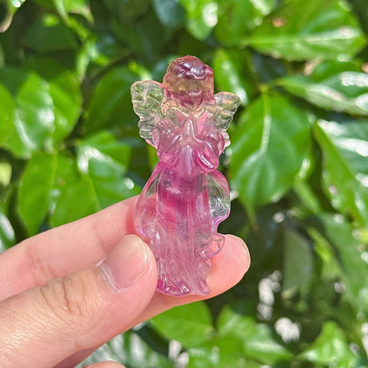 Rainbow Fluorite angel carving in a gentle pose, emphasizing the bright purple and clear wings