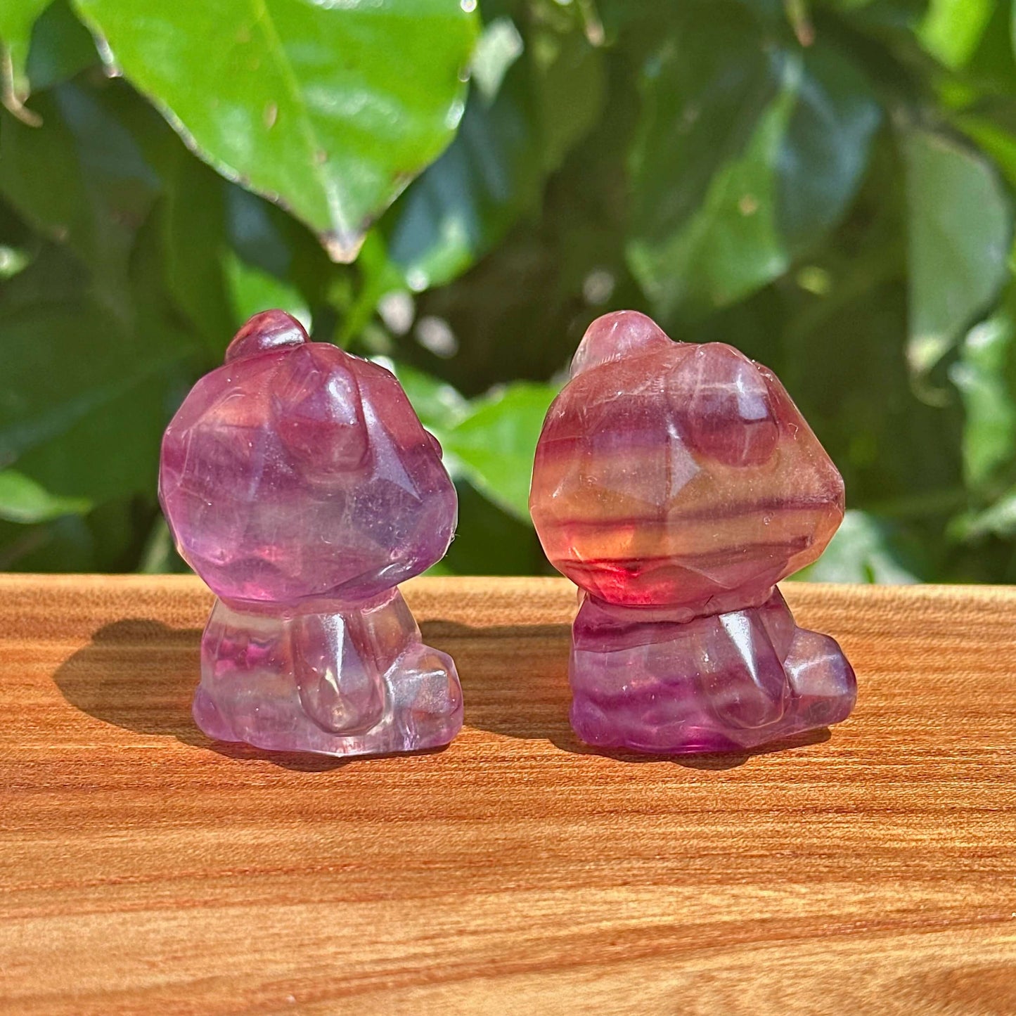 Close-up view of a Rainbow Fluorite Bear Carving highlighting the crystal's natural clarity and color transitions.