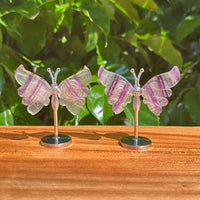 Elegant Rainbow Fluorite Butterfly crystal sculpture with intricate wings, showcasing vibrant purple and green natural coloring.
