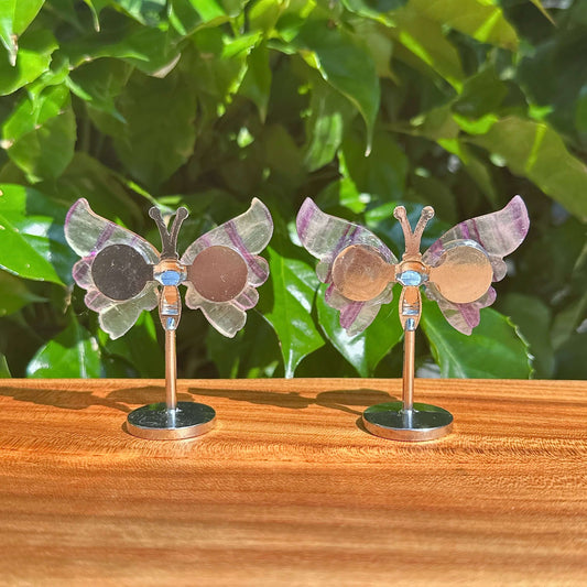 Close-up of a Rainbow Fluorite Butterfly figurine, highlighting the delicate craftsmanship and vibrant natural colors of the gemstone.