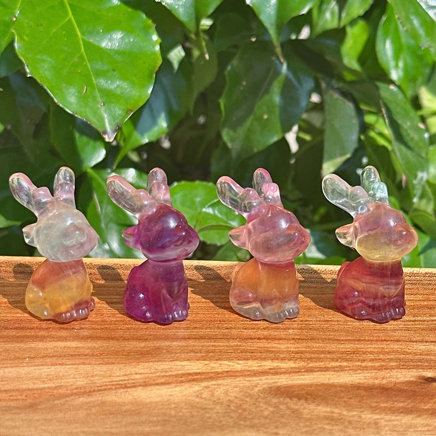 Rainbow Fluorite Deer Carving – A beautifully crafted crystal deer figurine with translucent details and colorful hues.