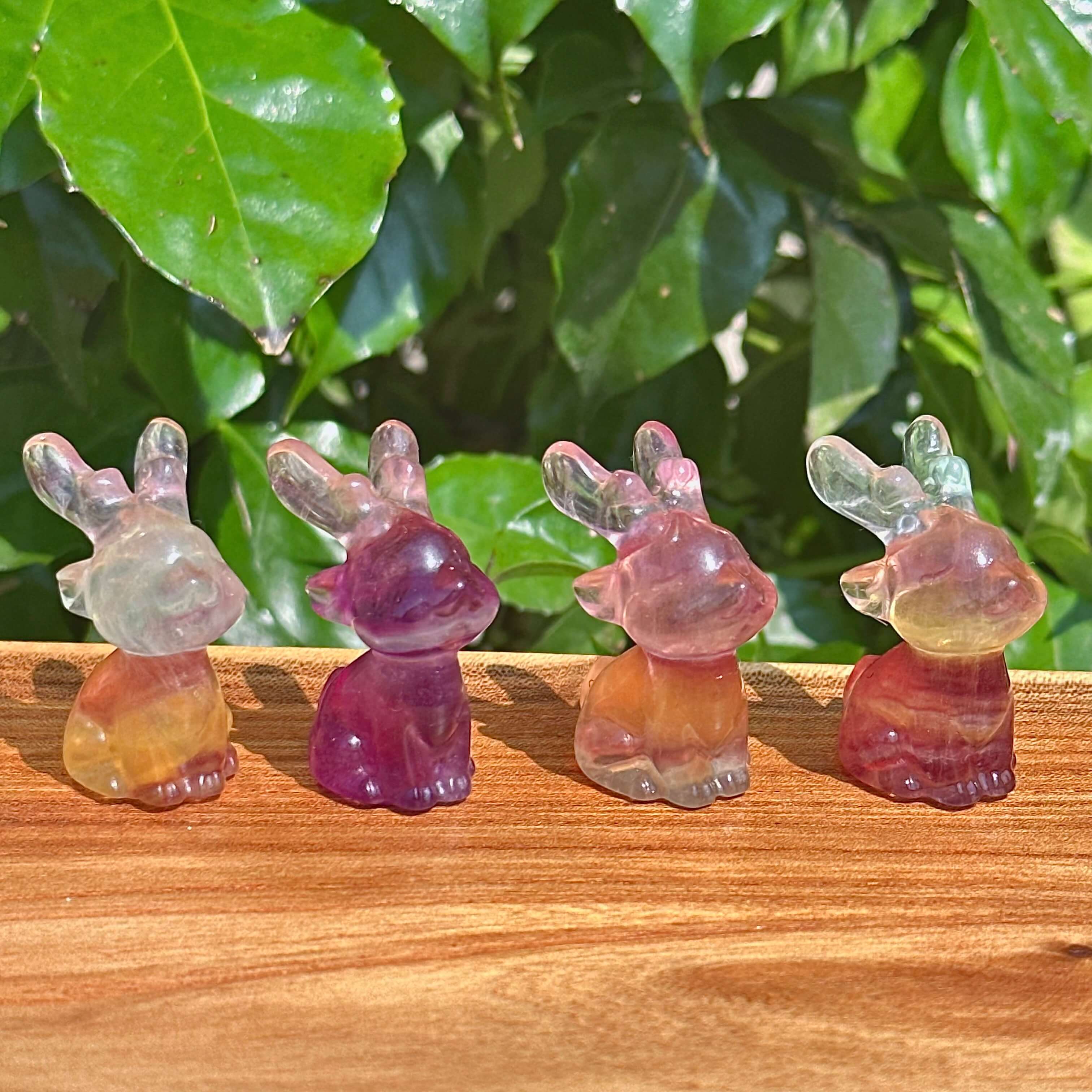 Rainbow Fluorite Deer Carving – A beautifully crafted crystal deer figurine with translucent details and colorful hues.