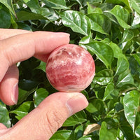 Pair of Rhodochrosite Spheres showcasing natural swirling colors
