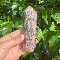 Rhodonite Tower with intricate black veins, offering both beauty and healing energy for your space.
