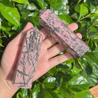 Detailed shot of a Rhodonite Tower with distinct color patterns, perfect for display and meditation.