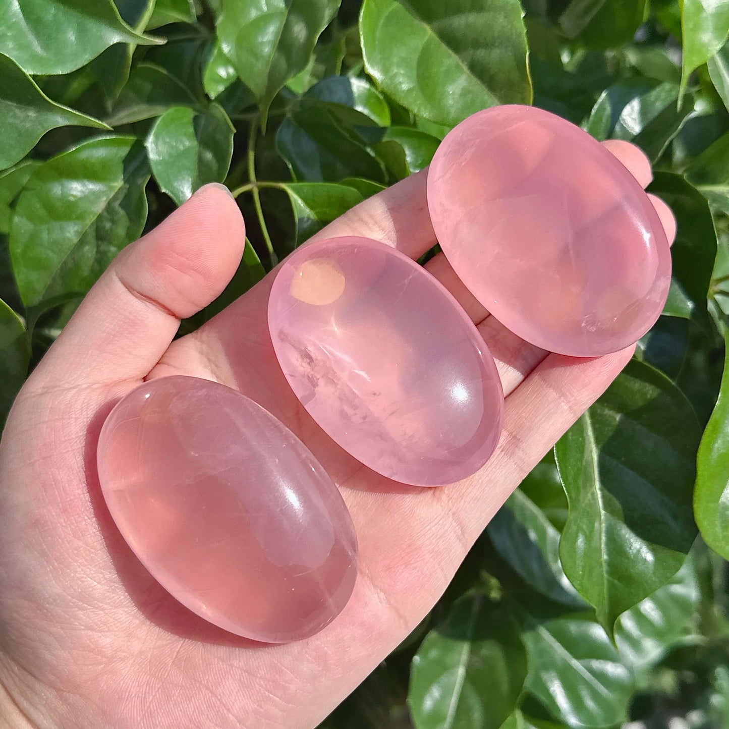 Close-up view of Rose Quartz Palm crystal, emphasizing its gentle pink hues that promote self-love and inner peace.