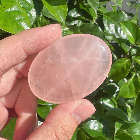 Close-up of Rose Quartz Palm, highlighting its natural texture and gentle pink glow, perfect for emotional healing.