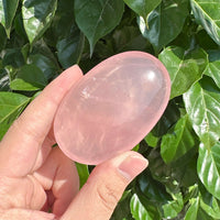 Side view of Rose Quartz Palm, highlighting its smooth, polished surface and gentle color tones for emotional balance.