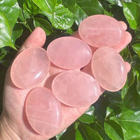 Side view of Rose Quartz Palm, highlighting its natural clarity and gentle pink tones.