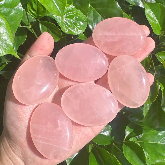 Side view of Rose Quartz Palm, highlighting its natural clarity and gentle pink tones.
