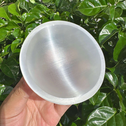 Clear Selenite Bowl radiating calming energy, perfect for use in healing rituals or as a unique gift.